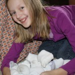Hoarding all the snow balls at her fort.